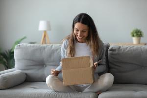 woman opens packaging happily